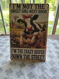 I'm Not the Sweet Girl Next Door, I'm the Crazy Heifer metal sign
