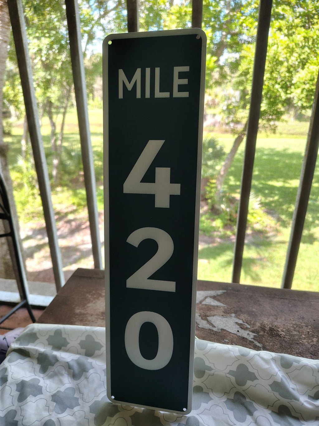 Mile 420 metal sign
