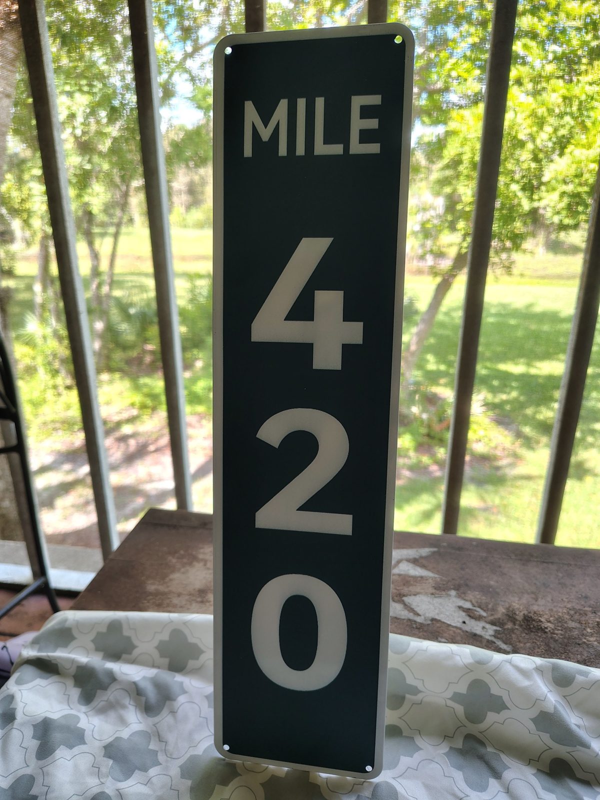 Mile 420 metal sign