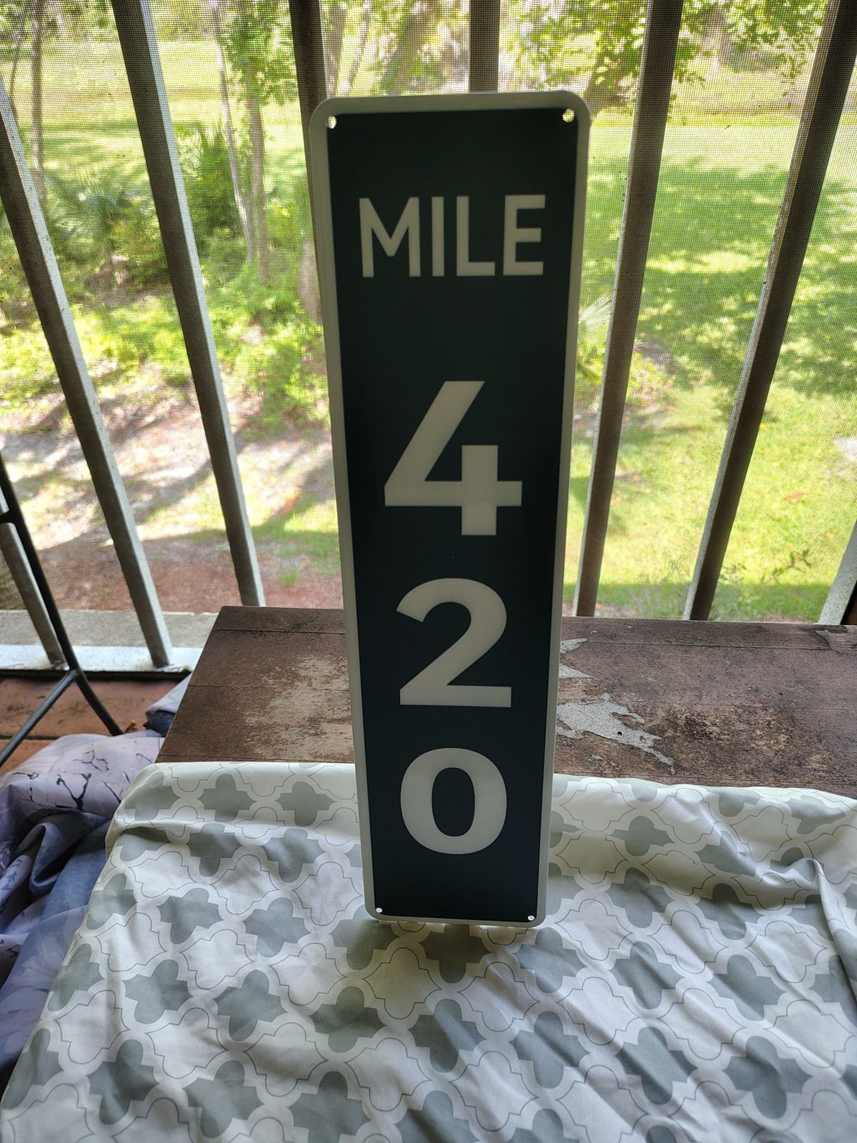 Mile 420 metal sign