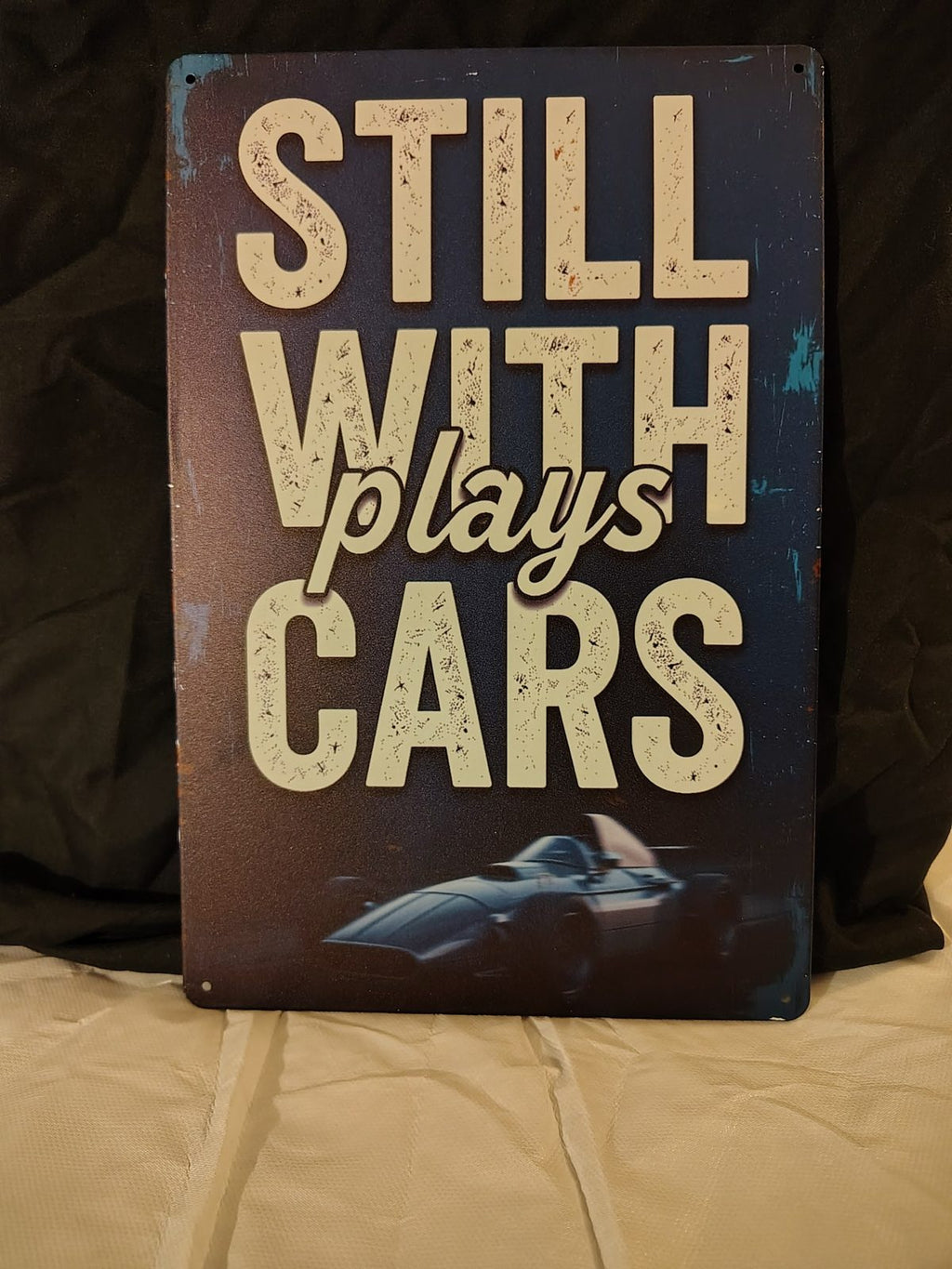 Still Plays With Cars metal sign