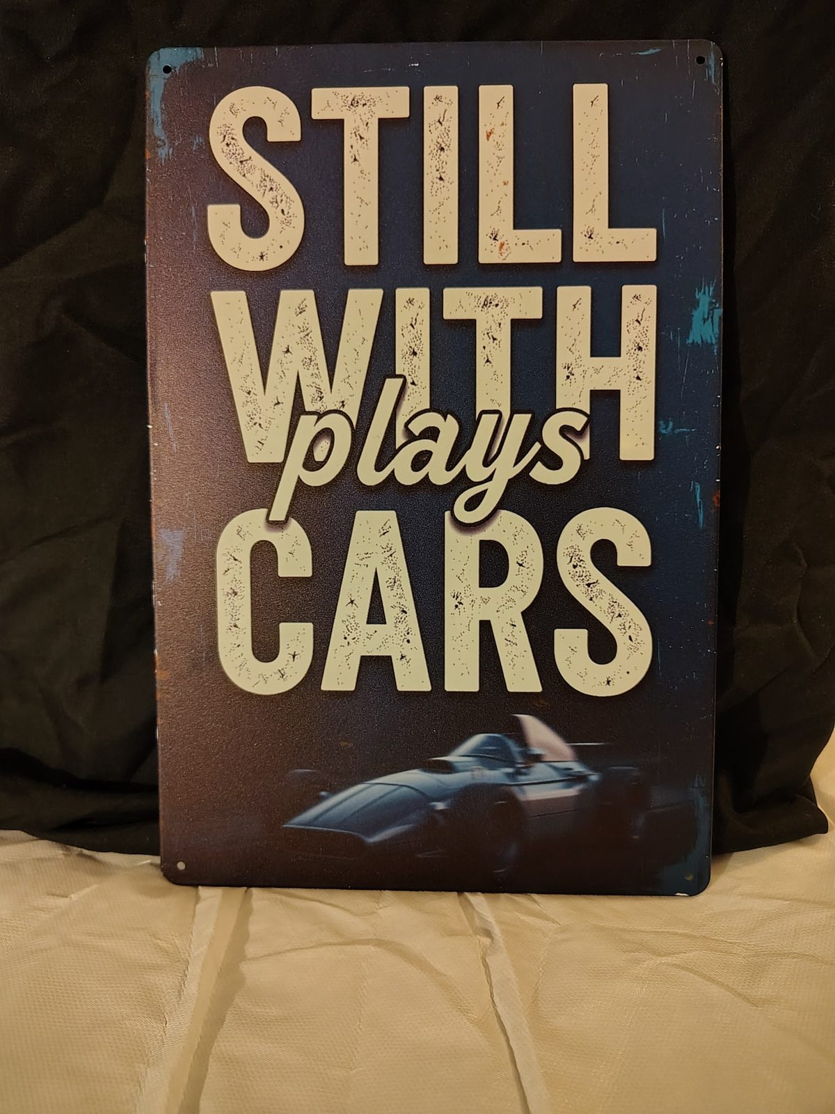 Still Plays With Cars metal sign