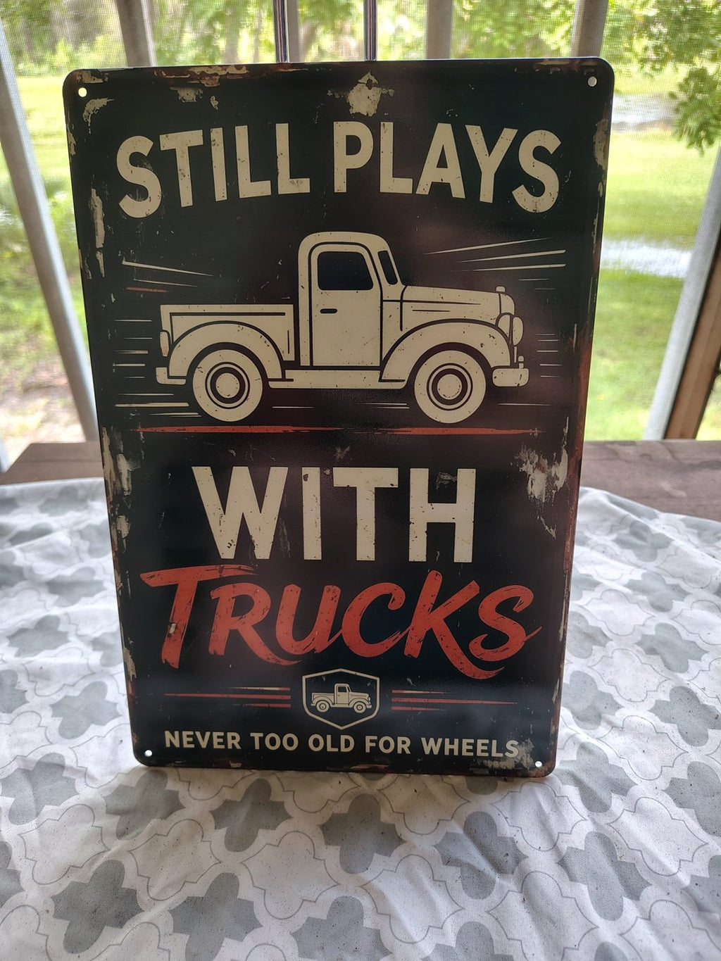Still Plays With Trucks metal sign