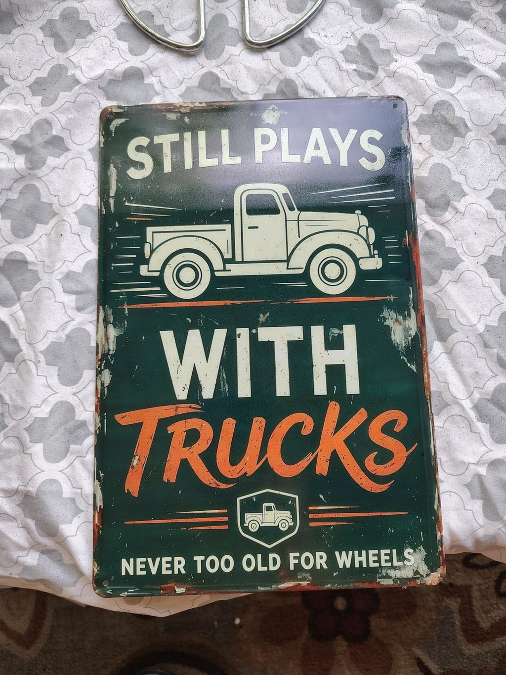 Still Plays With Trucks metal sign