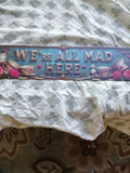 We're All Mad Here metal sign